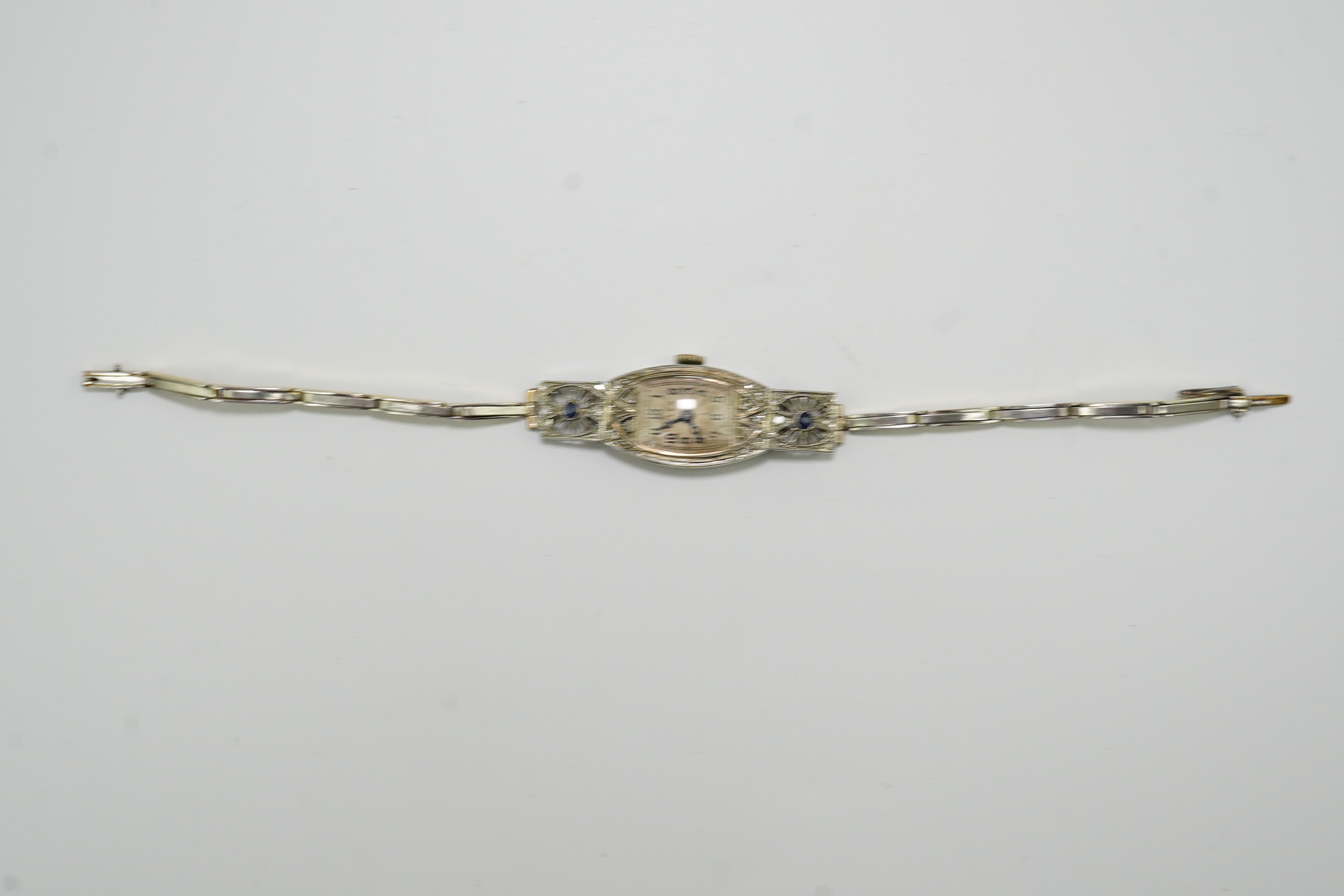 A lady's 1930's Art Deco pierced 18ct gold, sapphire and diamond set Rolex manual wind cocktail watch, on an 18ct gold and platinum expanding bracelet